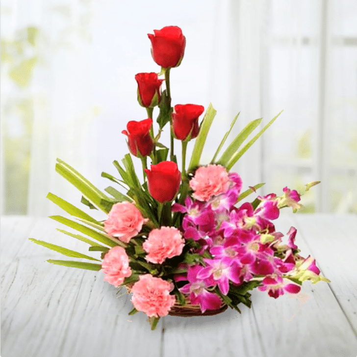 Ro. 36 849 ( 5 red roses 5 Baby pink carnation and 4 pcs orchis arranged in basket )